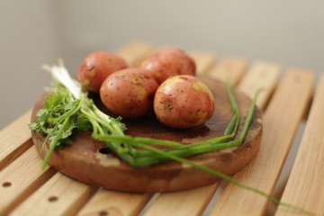 Sliced, peeled raw potatoes with a knife on  board