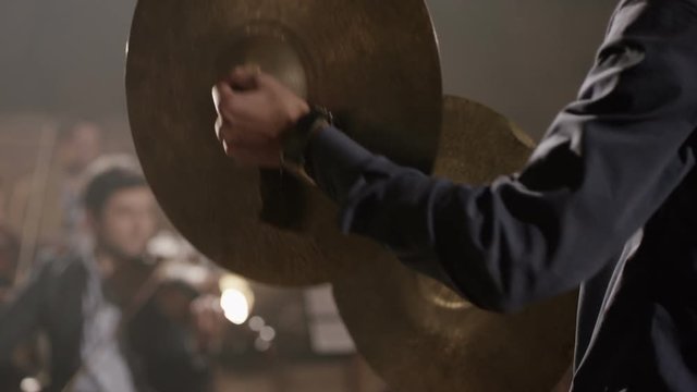 Man playing on ride cymbal on the symphony hall. Shot on RED EPIC Cinema Camera in slow motion.