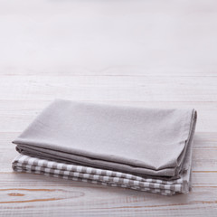 Napkins on table in perspective. Empty napkins mock up for design. Napkins top view close up. Place for text on napkin or white wooden table.