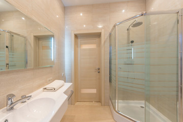 Bright bathroom interior with glass shower
