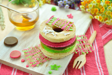 Stack of color pancake with honey and flower.