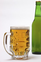 beer mug and green bottle on white background