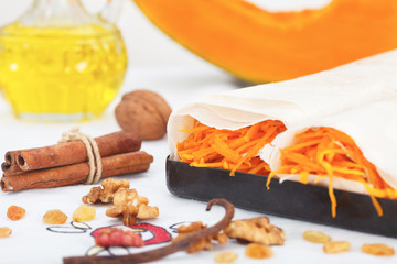 Making sweet pumpkin roll pie  with walnuts and cinnamon