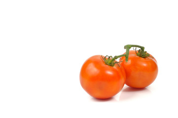 Double red tomatoes on white background.