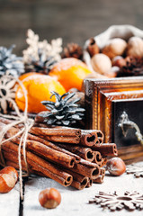 Christmas composition, Tangerines, pine Cones, Snowflakes ,decor, Bunch of Cinnamon, Walnut. Wooden Background.