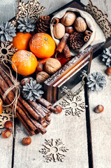 Merry Christmas Background.Tangerines, pine Cones, Snowflakes ,decor, Bunch of Cinnamon, Walnut. Wooden Background.The view from the top.