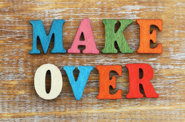 Makeover written with colorful wooden letters on rustic surface
