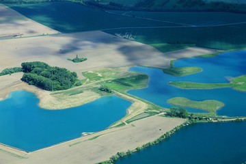 Aerial view on a blue lakes and fields