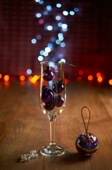Glass of champagne with Christmas tree decorations
