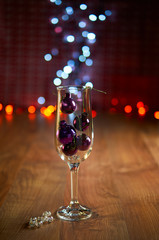Glass of champagne with Christmas tree decorations