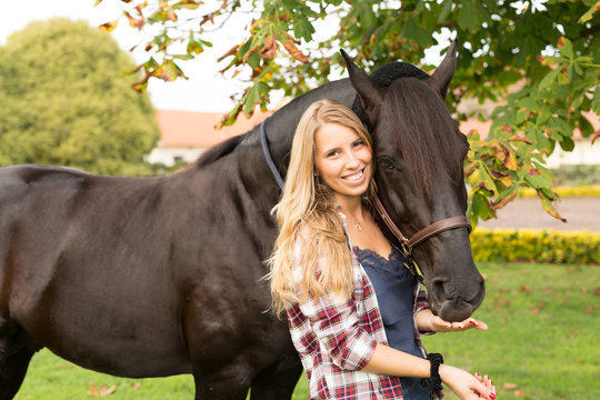 Young beautiful woman with a horse
