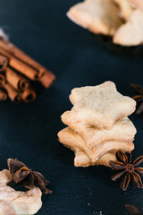 Star shaped cookies with cinnamon and anise on the table