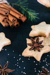 Star shaped cookies with cinnamon and anise on the table