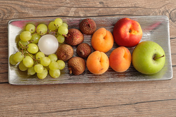 Fruit displayed on a silver plate to be used as a center piece 