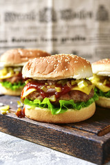 Cheeseburger with meat cutlet and pickled vegetable.