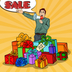 Pop Art Man with Megaphone Promoting Big Sale Standing in Gift Boxes. Vector illustration