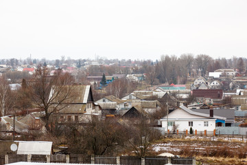 Fototapeta na wymiar A small town in Central Russia. small house,Well hill Orthodox C