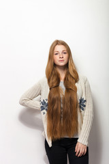 Human pose expressions and emotions. Portrait of young adorable redhead woman showing her gorgeous extra long natural red hair in cozy sweetshirt