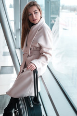 Passenger woman in airport waiting for air travel.