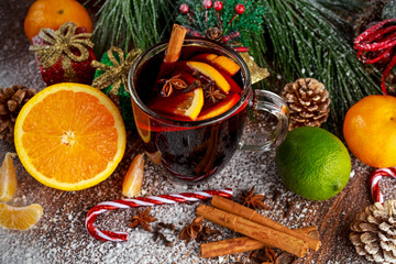 Obraz na płótnie Canvas Hot Mulled wine with cinnamon sticks, orange, lime. christmas concept.