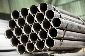 Stainless steel bars and pipes deposited in stacks