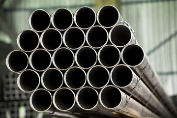 Stainless steel bars and pipes deposited in stacks