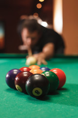 Player breaks a pyramid in billiards.