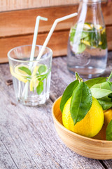 Lemon and lemonade on a wooden background