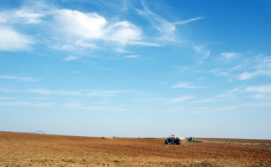 Fototapeta na wymiar Farmers preparing land and fertilizing, alentejo, Portugal