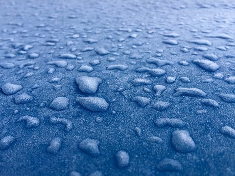 Frozen Water Drops Beads On Blue Metal