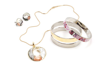 Earrings, pendant and bracelets on white background - fashion jewelry set