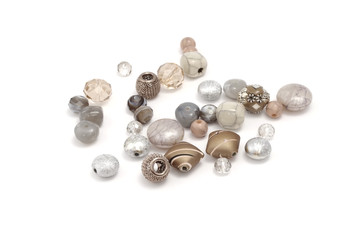 Decorative colorful beads scattered on white background - accessories for handmade and hobby