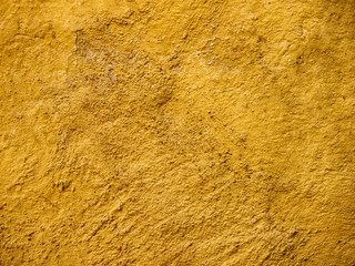 Abstract gold textured background with spotlight and scratches.