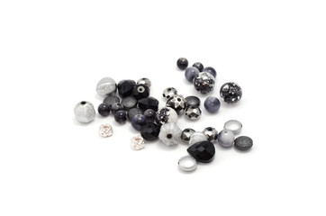 Decorative colorful beads scattered on white background - accessories for handmade and hobby
