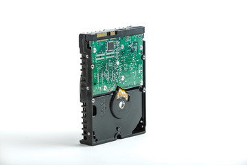 Black and silver desktop 3.5 inch hard disk. The disc has a vertical position, SATA connector upwards. View of the backside HDD, from the PCB. Isolated on white background.