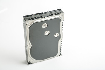 Black and silver desktop 3.5 inch hard disk. The disc has a vertical position, SATA connector upwards. Isolated on white background.