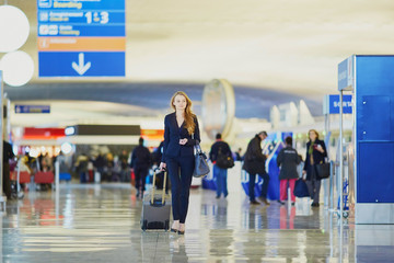 Business woman with hand luggage in international airport