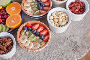 Smoothie  with fruits and berries on the grey wooden table, with variety of fruits around, selective focus