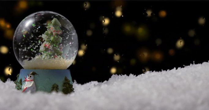 Christmas snow globe with tree on winter background