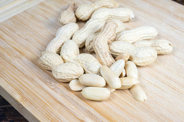 dried fruit, nuts, hazelnuts and almonds on cutting board and antique table