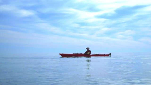 Man paddle kayak on sea. Kayaking. Kayak paddle. Man kayaking on blue sea landscape. Sea kayaking. Canoeing sea. Summer nature and canoeing person. Healthy vacation water sport. Kayaking ocean