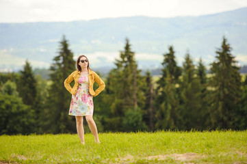 Obraz premium Brunette girl enjoying journey in mountains.