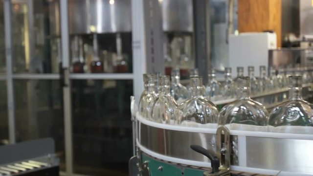 Bottles on assembly line inside bottling facility of Kentucky bourbon distillery.
