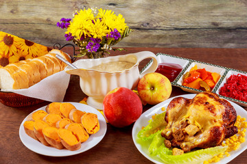 Roasted chicken. Thanksgiving table served with , decorated bright autumn leaves and candles. ,