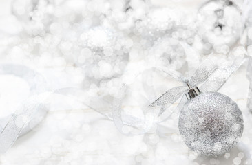 Silver Christmas ball with ribbon on white spakles bokeh light b
