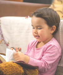 Fototapeta na wymiar Cute little child girl reading a book