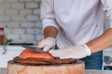 Chef cutting fresh salmon