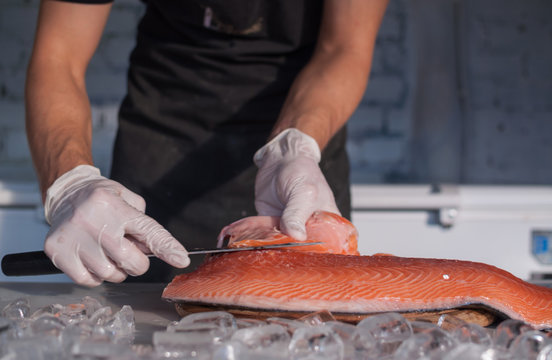 Chef cutting fresh salmon