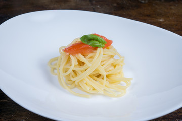 italian spaghetti with tomato and basil in a pot