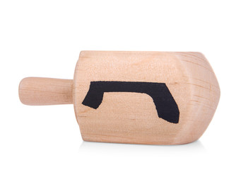 Wooden dreidel for Hanukkah on white background